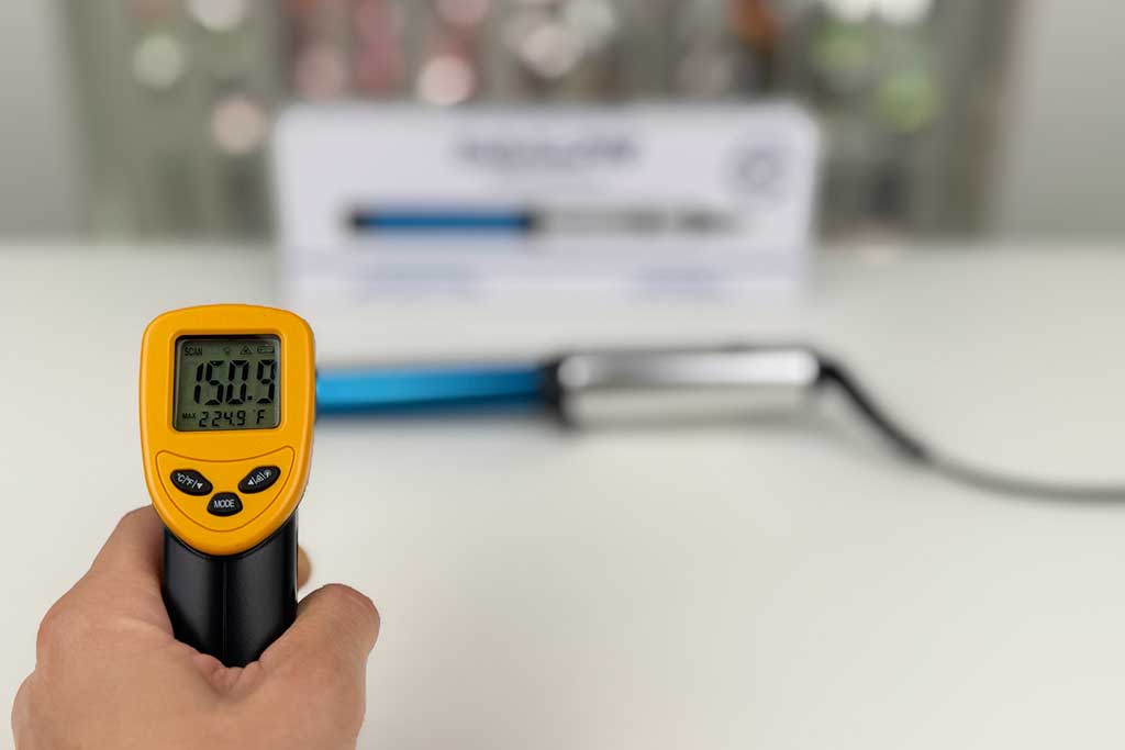 Thermometer pointed at BaBylissPRO Compact Wand cool tip reading 150°F.