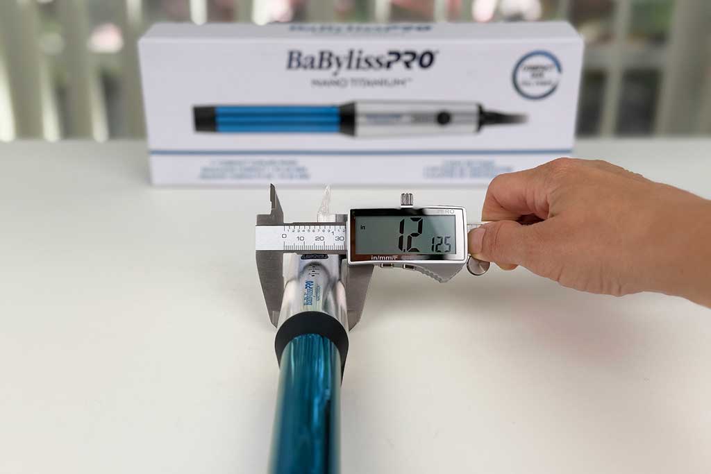 Digital caliper reading 1.2 inches across the handle of the compact curling wand.