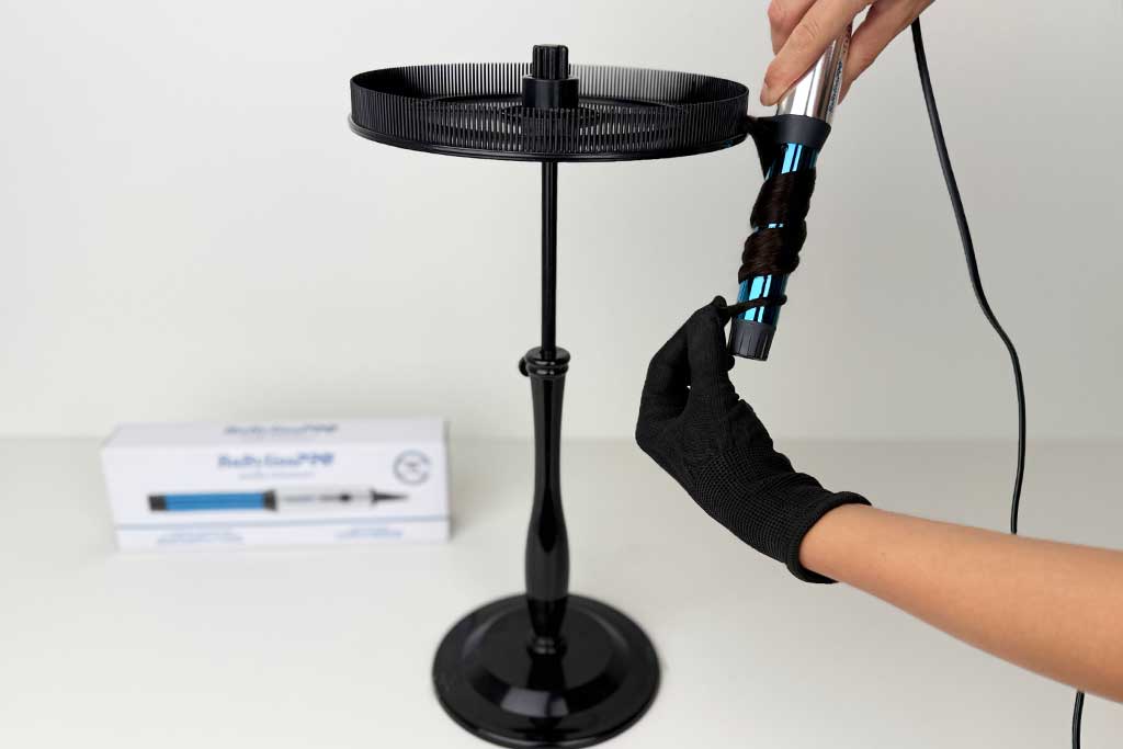 Wig hair wrapped around the 1″ barrel of the BaBylissPRO Compact Curling Wand.