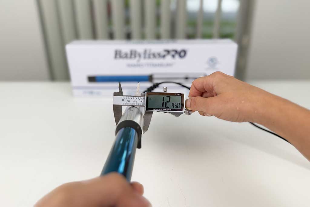 Caliper measuring the 1.2-inch handle width of the BaBylissPRO Curling Wand.