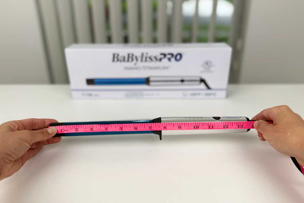 Measuring tape showing the 13.5-inch length of the BaBylissPRO Curling Wand.
