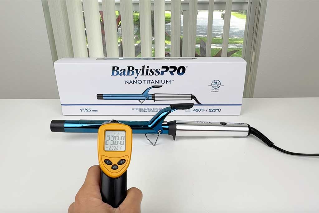 Infrared thermometer pointed at BaBylissPRO Extended Barrel surface showing even heat distribution.