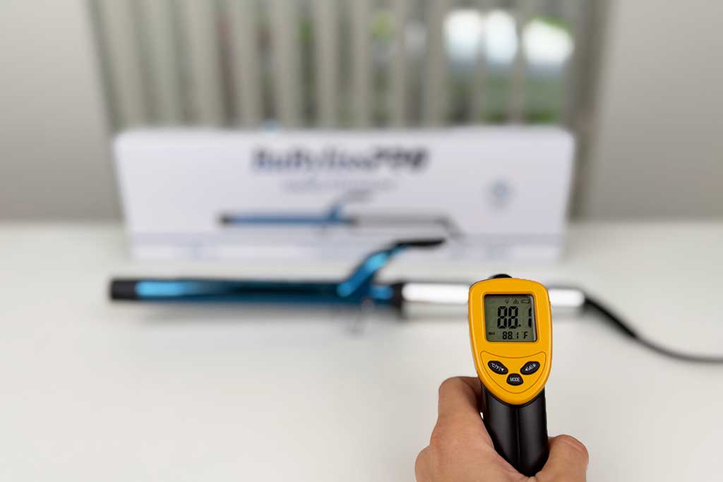 Infrared thermometer measuring 88°F on the handle of the BaBylissPRO Extended Barrel Curling Iron.