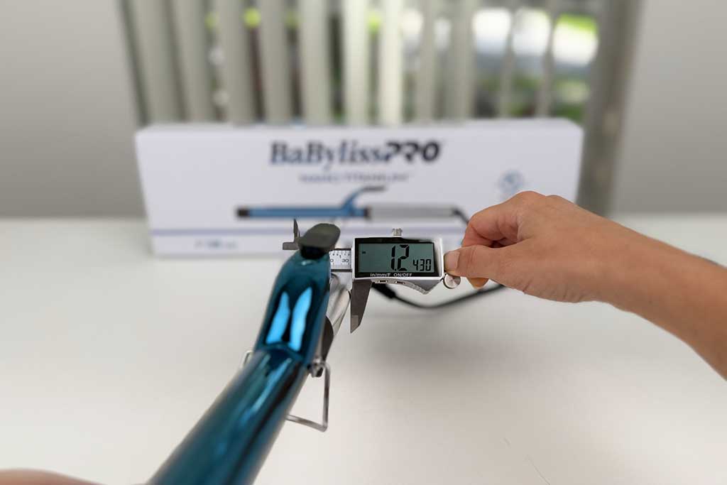 Caliper measuring 1.2-inch handle width of the BaBylissPRO Nano Titanium Extended Barrel Curling Iron.