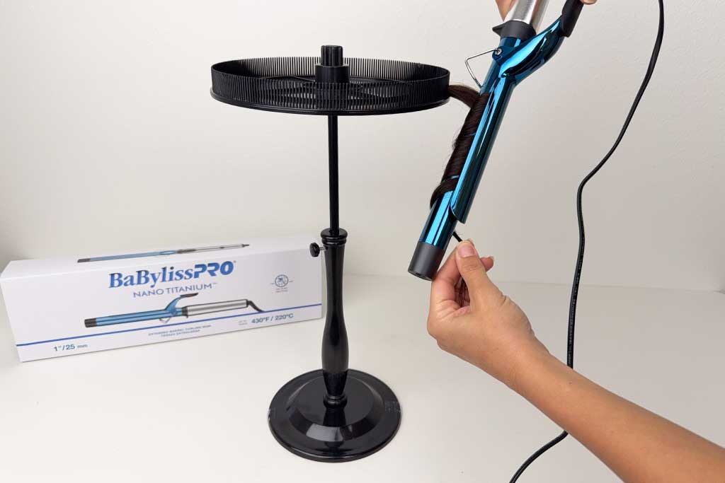 Human hair wig section wrapped around the 7-inch extended barrel of the BaBylissPRO Nano Titanium curling iron.