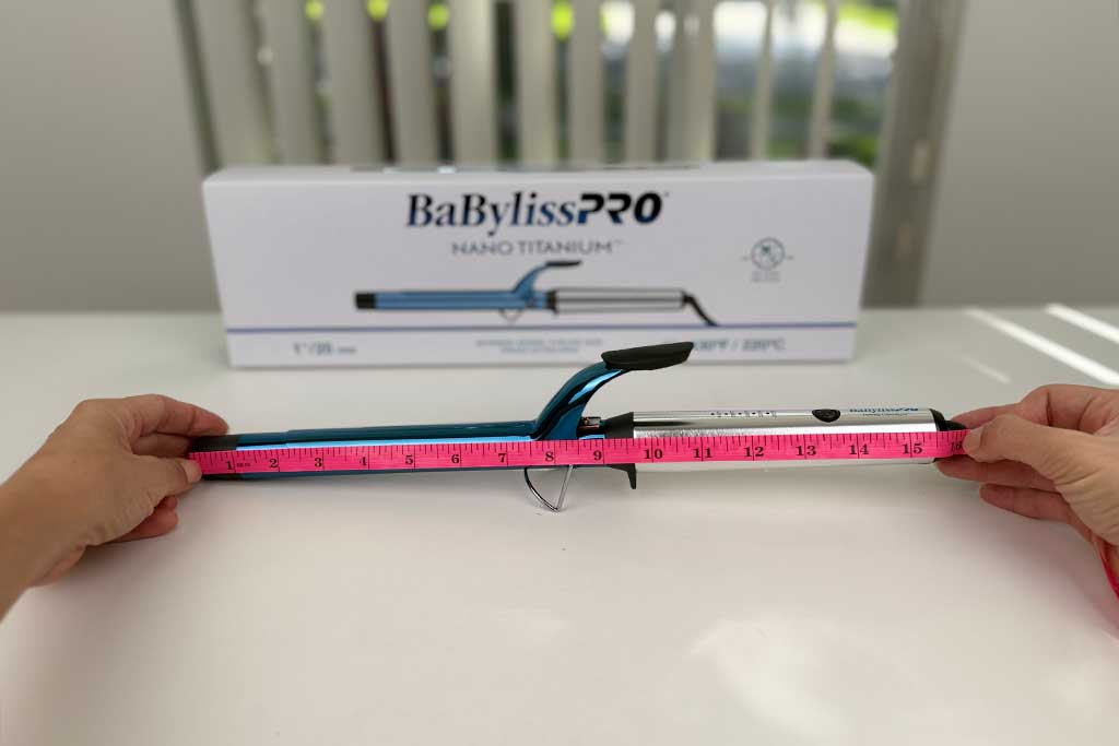 Measuring tape showing the full 15.5-inch length of the BaBylissPRO Extended Barrel Curling Iron.