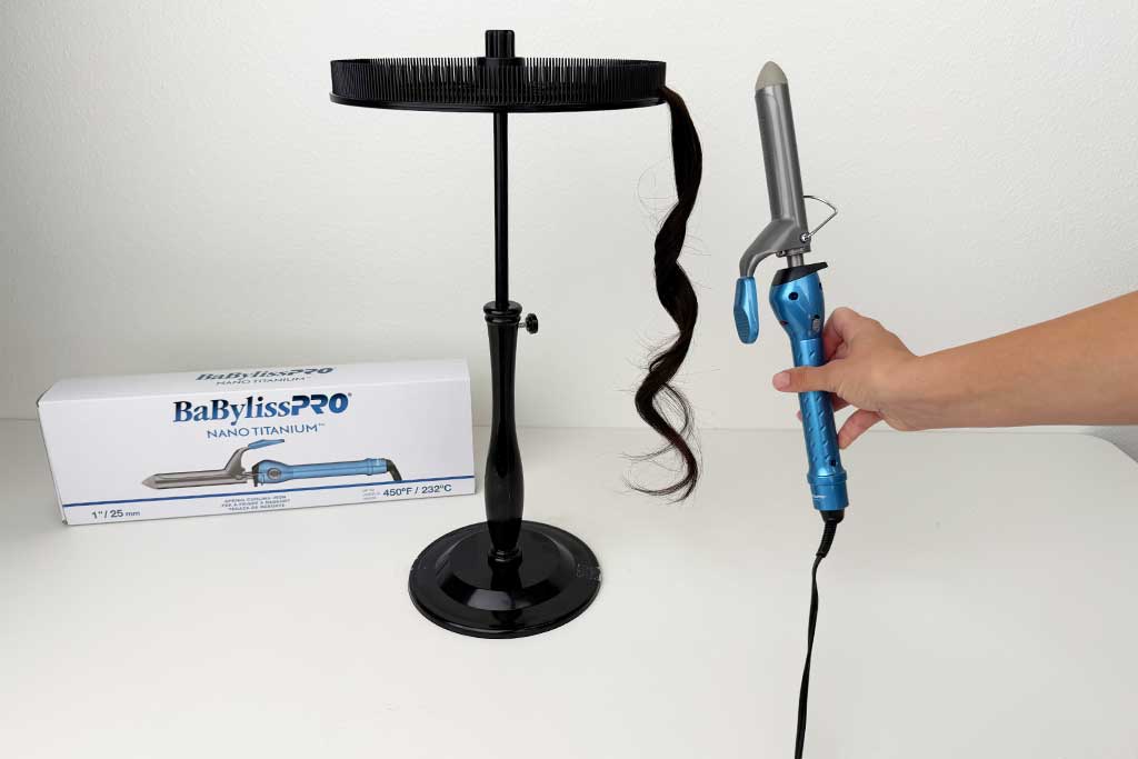 Close-up of defined curls formed on wig hair with the BaBylissPRO Nano Titanium Spring Curling Iron.