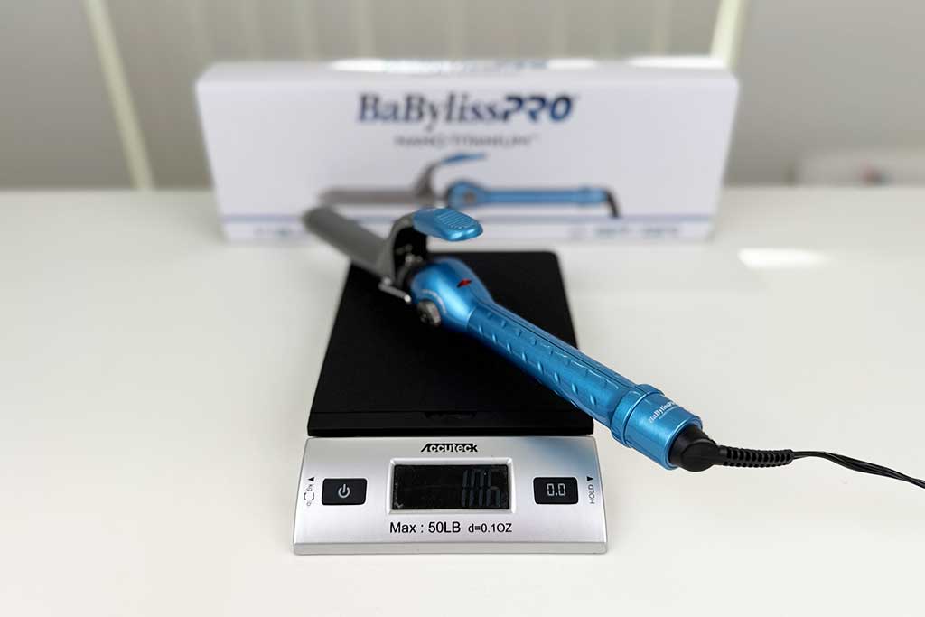 Digital scale reading 10.6 oz with the BaBylissPRO Nano Titanium Spring Curling Iron on top.