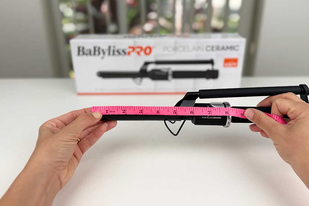 Caliper measuring the 5.25-inch barrel length of the BaBylissPRO Marcel Curling Iron.