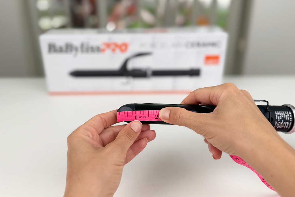 Caliper showing 0.8-inch cool tip length on the BaBylissPRO Porcelain Ceramic Spring Curling Iron.