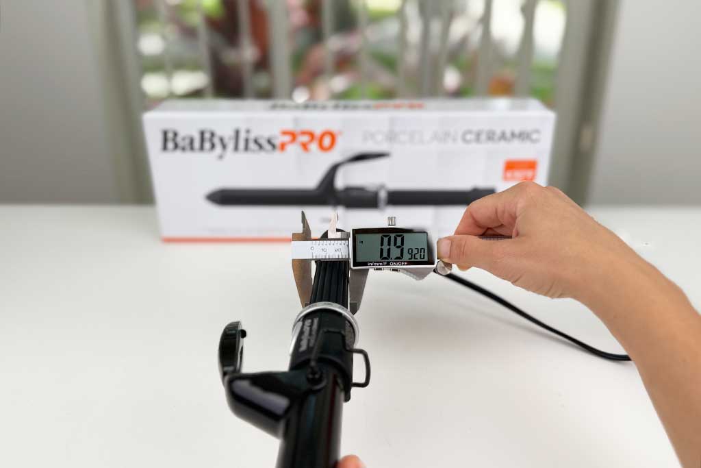 Caliper measuring the 1-inch handle width of the BaBylissPRO Porcelain Ceramic Spring Curling Iron.