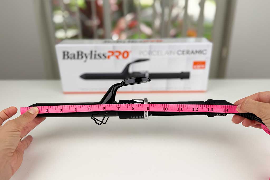 Measuring tape showing the 14-inch total length of the BaBylissPRO Porcelain Ceramic Spring Curling Iron.