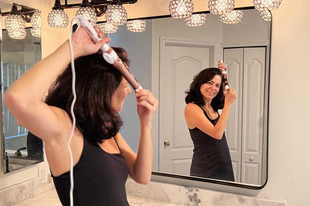 Conair-Double-Ceramic-Spring-Curling-Iron-in-use-in-testers-hand