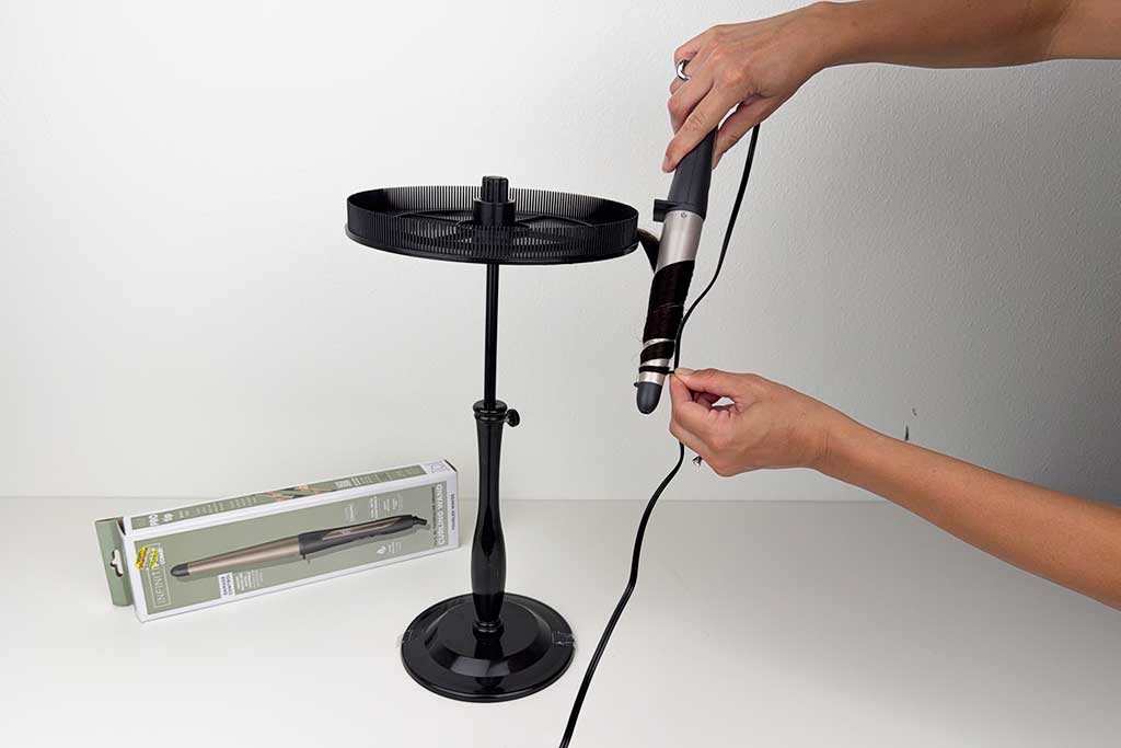 Wig hair wrapped around a Conair InfinitiPro tapered curling wand during testing