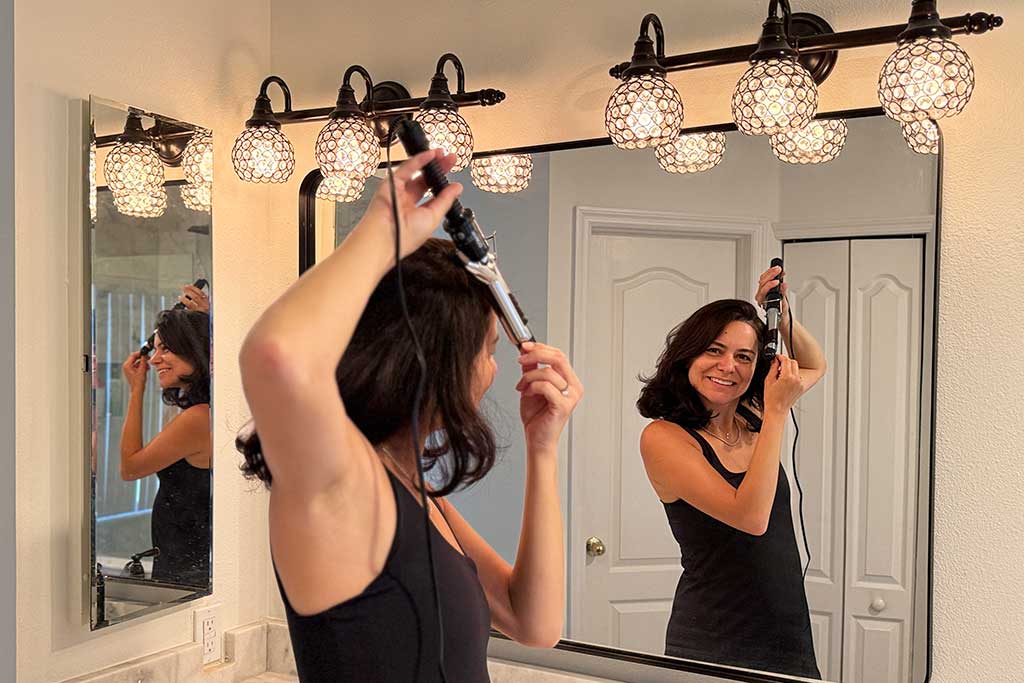 Conair-Instant-Heat-Spring-Curling-Iron-in-use-in-testers-hand
