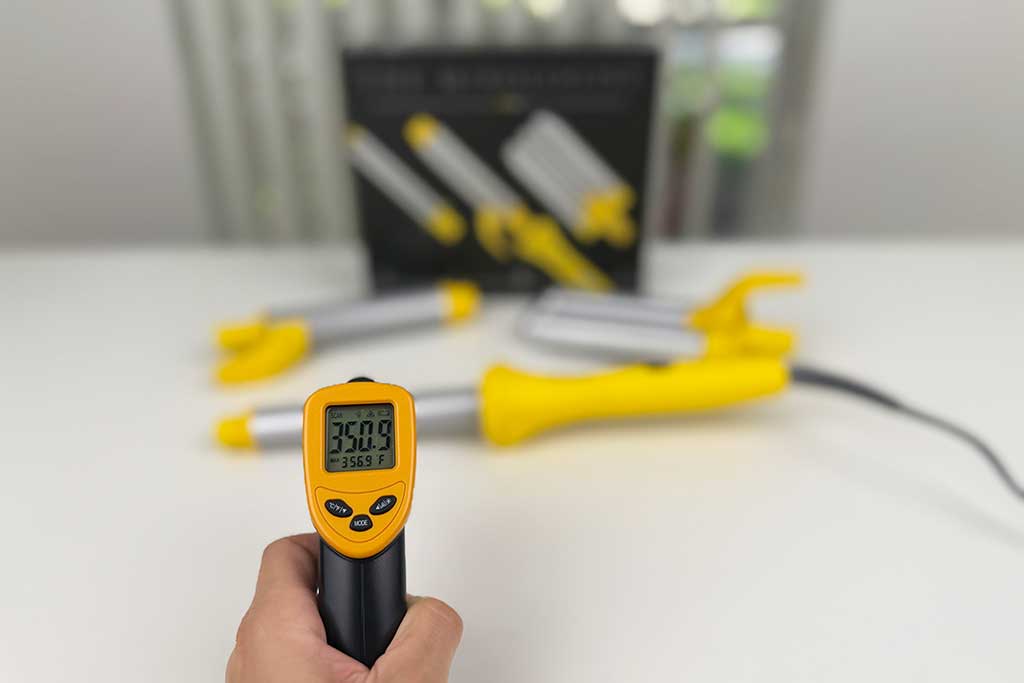 Infrared thermometer reading 390°F on the Drybar Mixologist wand barrel, showing even heat for every attachment.