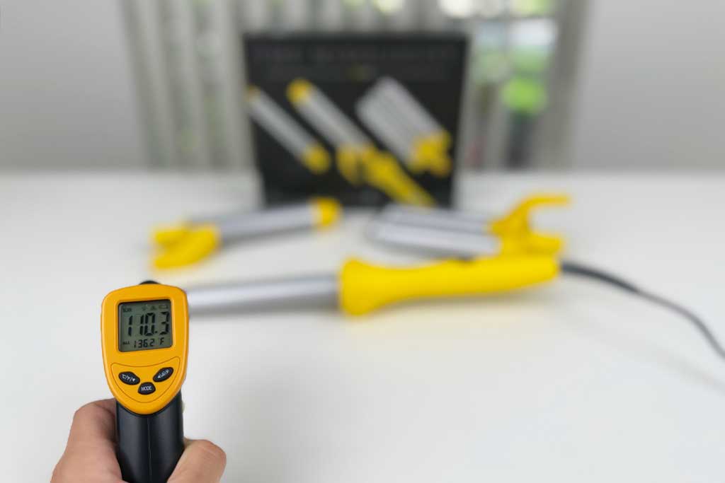 IR thermometer showing 95°F on the cool tip of the Drybar Mixologist spring curling iron.