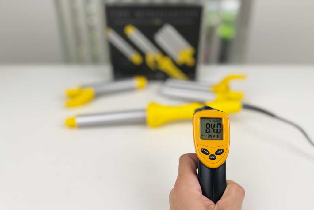 Infrared thermometer measuring 85°F on the handle of the Drybar Mixologist.