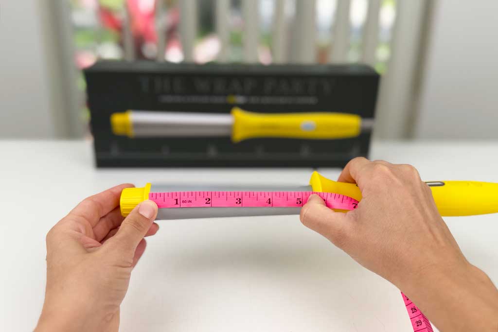 Digital caliper measuring the 5.25″ barrel of the Drybar Wrap Party Curling Wand.