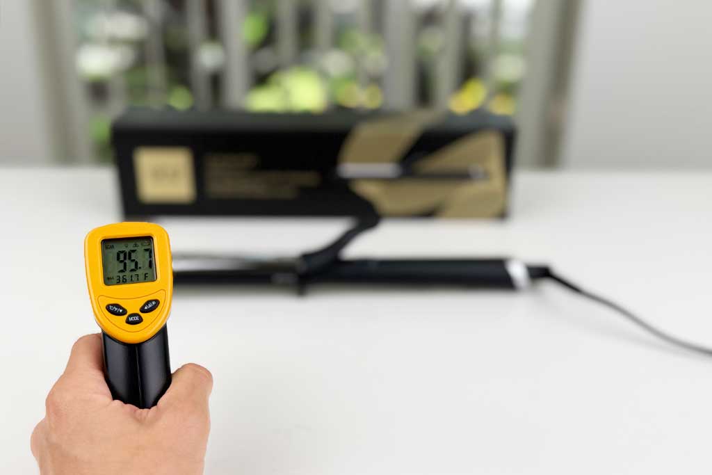 Infrared thermometer showing 95°F measured at the cool tip of the GHD Classic Curl Curling Iron.
