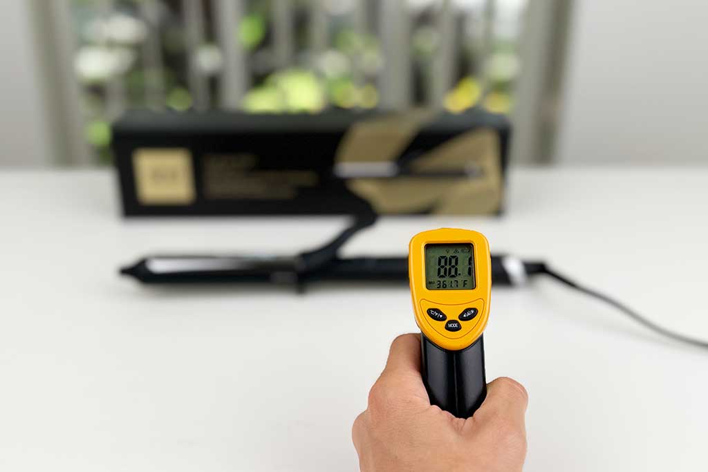 Infrared thermometer reading 88°F aimed at the handle of the GHD Classic Curl Curling Iron.
