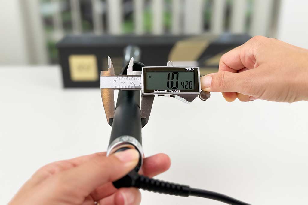 Digital caliper showing 1-inch handle width of the GHD Classic Curl Curling Iron.