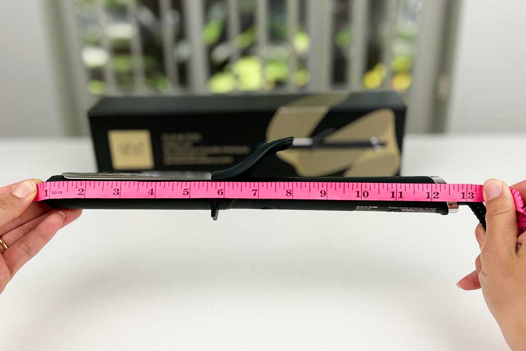 Measuring tape stretched along the GHD Classic Curl Curling Iron showing 13-inch tool length.