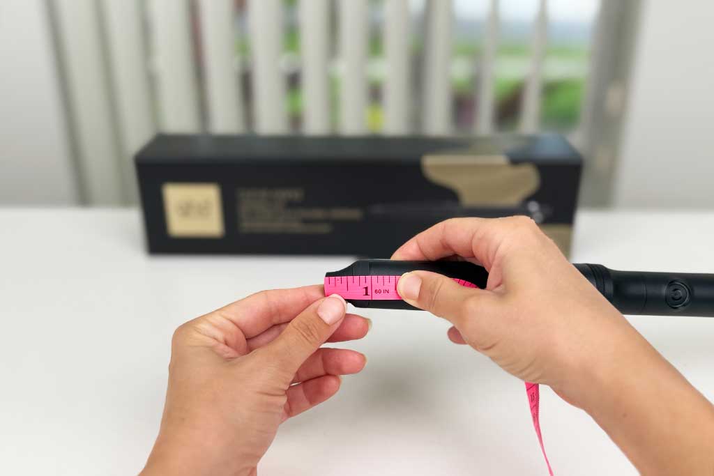 Digital caliper measuring the 1-inch cool tip of the GHD Creative Curl Wand, with infrared thermometer reading 95°F.
