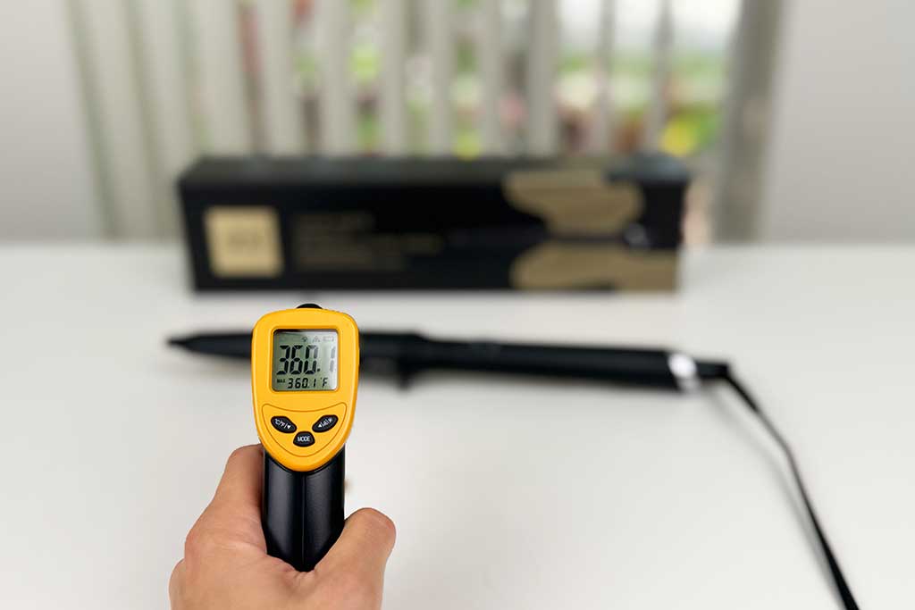 Infrared thermometer displaying 360°F while pointed at the ceramic barrel of the GHD Creative Curl Wand.