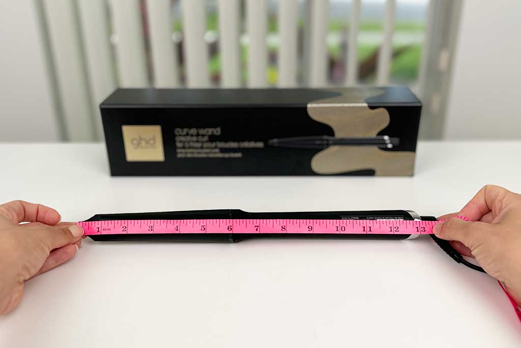Measuring tape alongside the GHD Creative Curl Wand showing 13 inches total length.