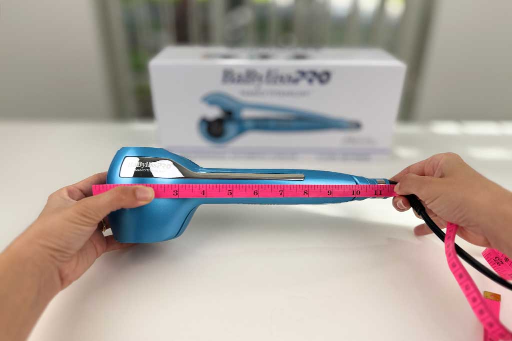 Measuring tape aligned with the full length of the MiraCurl 3 curler.