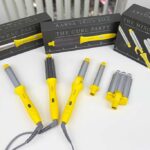Three Drybar curling tools (Wrap Party, Mixologist, Curl Party) arranged on a lab bench for comparison.