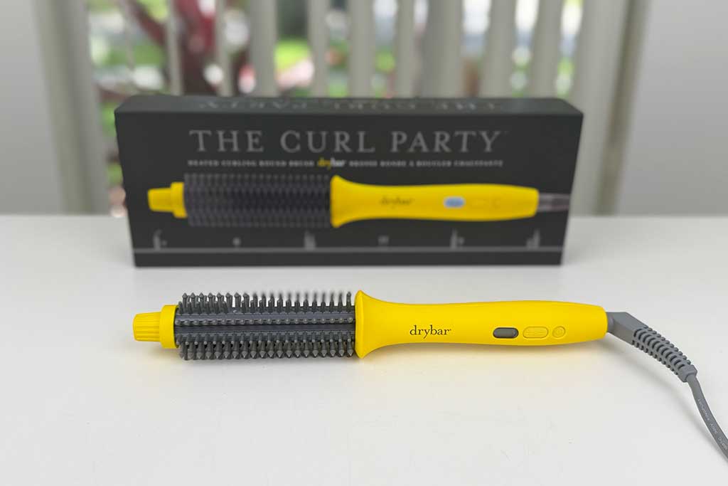 Drybar-The-Curl-Party-Heated-Curling-Round-Brush-review-featured Drybar The Curl Party curling brush photographed on a white surface with LED temperature display.