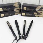 GHD Curling Irons lineup photographed at BeautiLAB Studio, including the Classic Curl Iron, Creative Curl Wand, and Classic Wave Wand, displayed side by side.