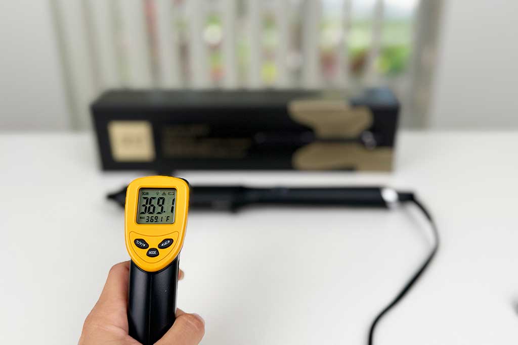 Infrared thermometer reading 360°F aimed at the barrel of the GHD Classic Wave Wand.