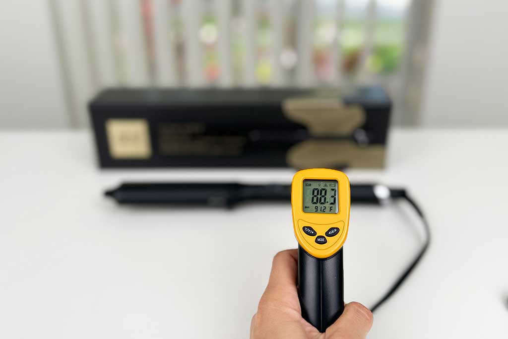 Infrared thermometer showing 88°F on the handle of the GHD Classic Wave Wand.
