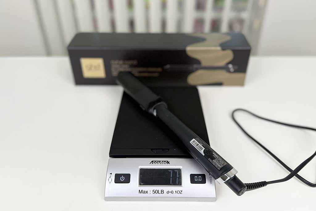 Digital scale displaying 9 ounces with the GHD Classic Wave Wand on top.