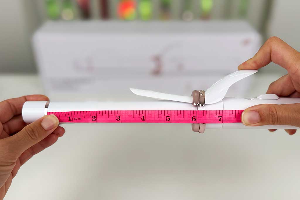 Measuring tape showing the 6-inch ceramic barrel length of the T3 CurlWrap curling iron.
