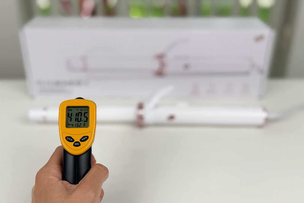 Infrared thermometer reading 410°F while pointed at the ceramic barrel of the T3 CurlWrap curling iron.