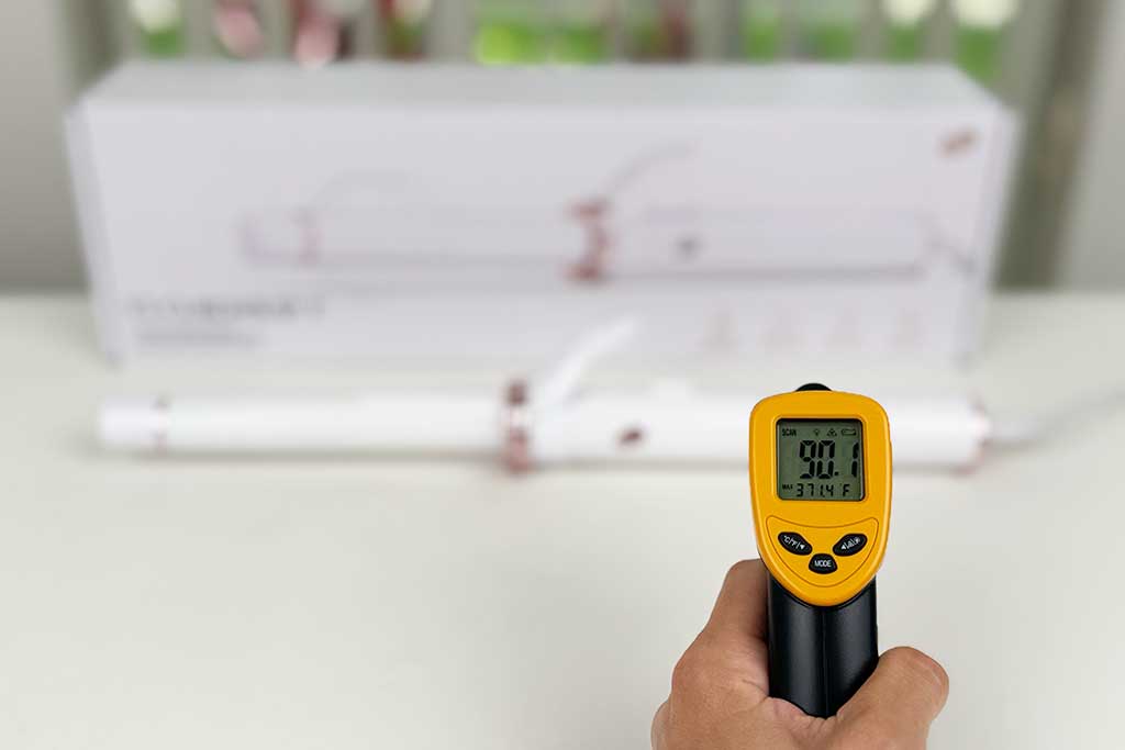 Infrared thermometer reading 90°F while aimed at the handle of the T3 CurlWrap curling iron.