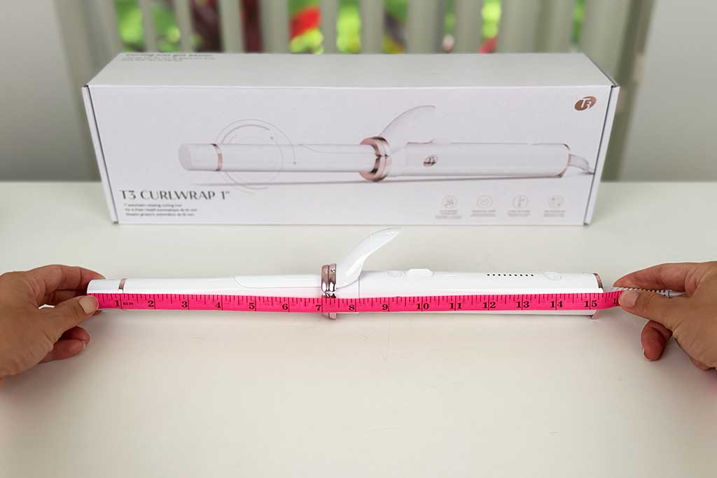 Measuring tape showing the full 15.5-inch length of the T3 CurlWrap curling iron on a flat surface.