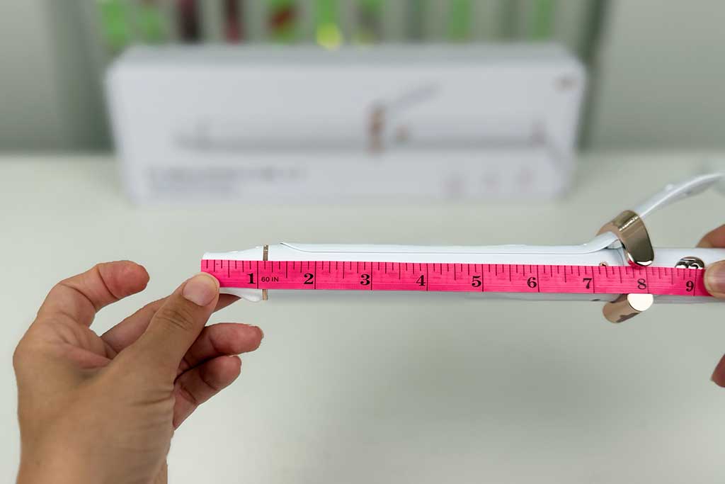 Digital caliper measuring the 1.2-inch cool tip of the T3 SinglePass Curl X curling iron, with thermometer showing 170°F heat reading.