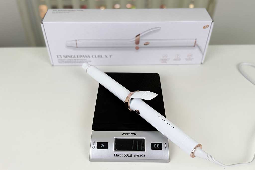 Digital scale displaying 11.1 ounces with the T3 SinglePass Curl X curling iron placed on top.