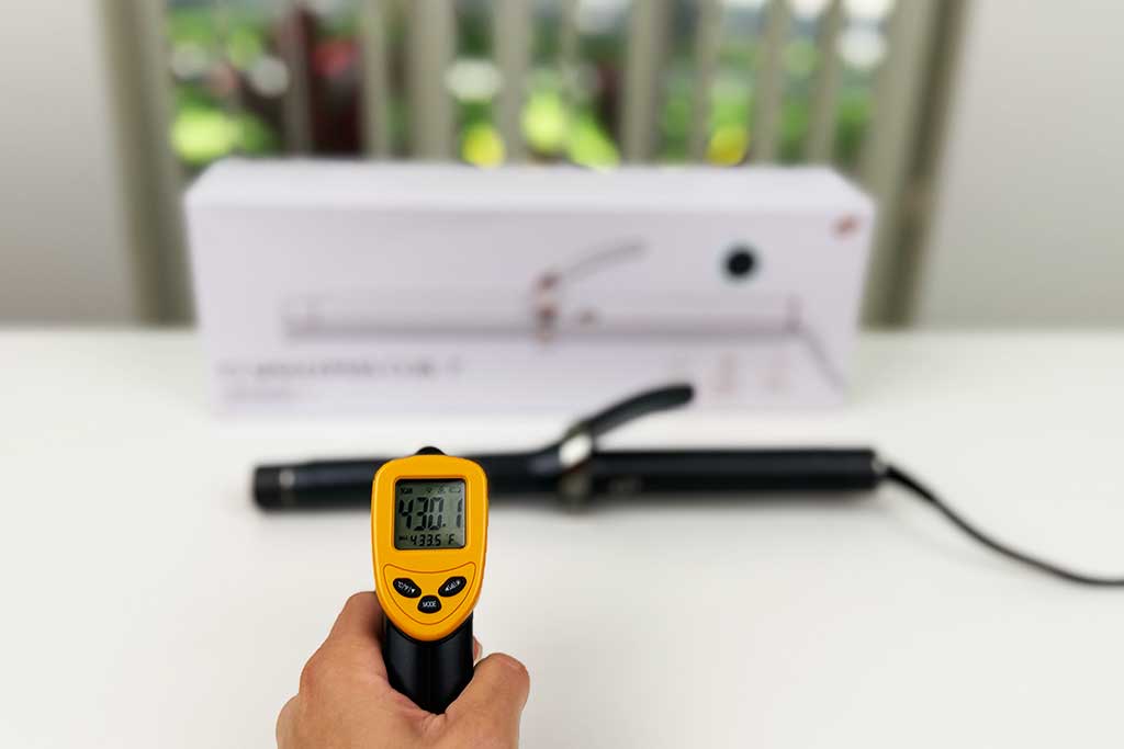 Infrared thermometer showing 430°F while aimed at the barrel of the T3 SinglePass Curl curling iron.