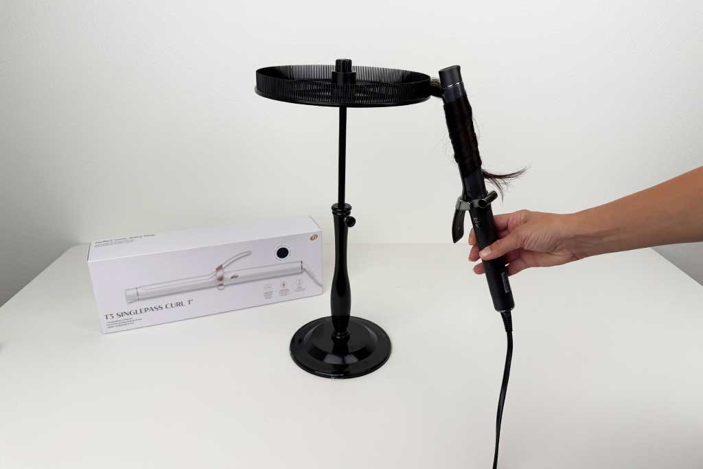 Hand wrapping wig hair around the barrel of the T3 SinglePass Curl curling iron during lab testing.
