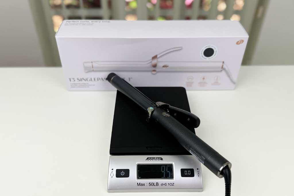 Digital scale displaying 9.5 ounces with the T3 SinglePass Curl curling iron placed on top.