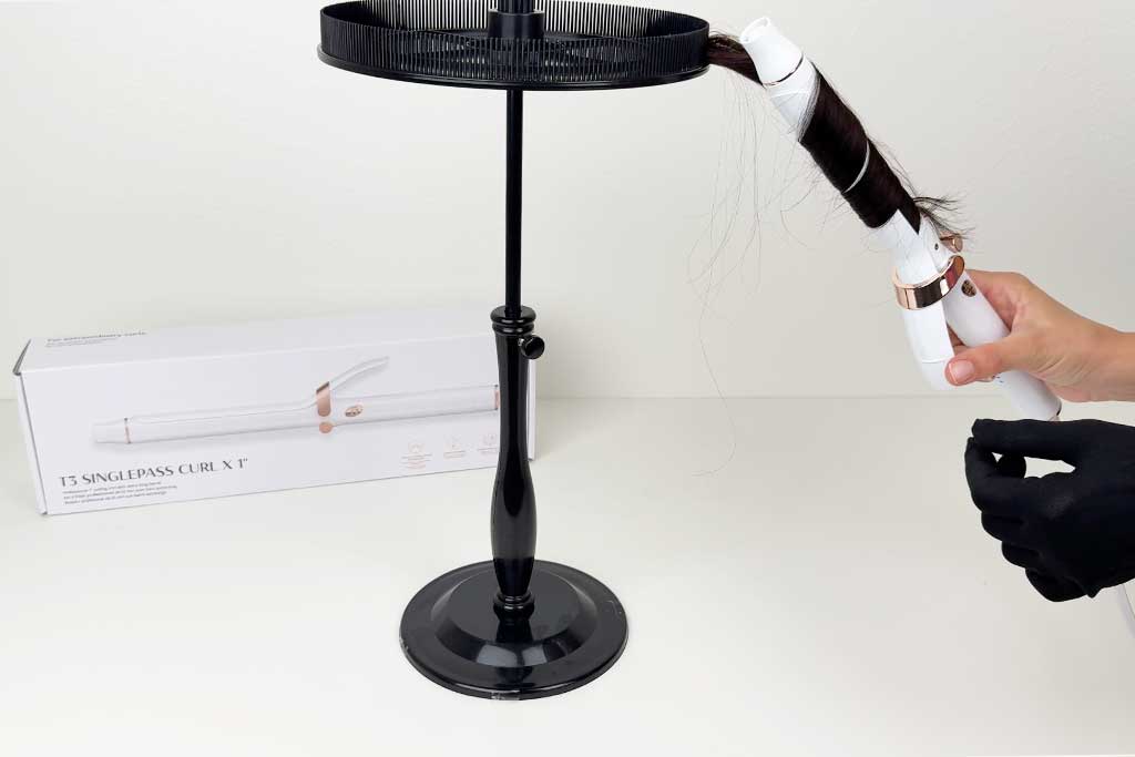 Hand wrapping wig hair around the 6.5-inch barrel of the T3 SinglePass Curl X curling iron during testing.